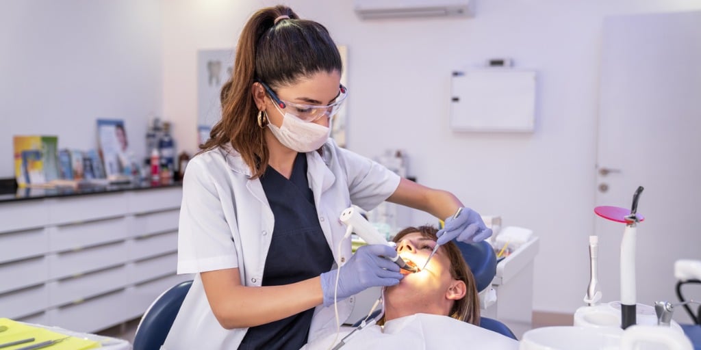 woman is getting dental treatment in a dentist clinic picture
